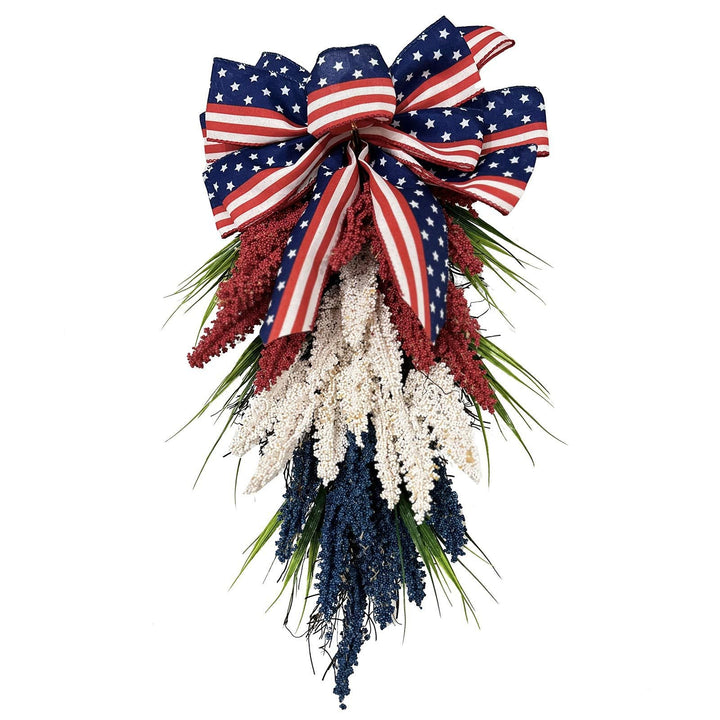Independence Day tapering teardrop door swag with wired stars-and-stripes bow and textured faux floral sprays Kalsten