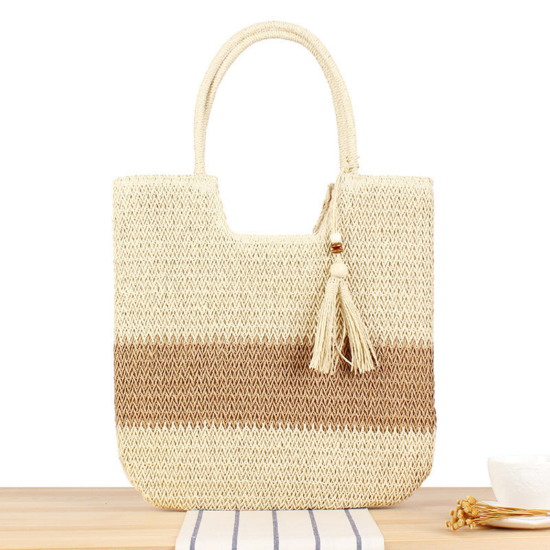 Fashionable beach tote bag made of woven natural material with fringed detail Kalsten