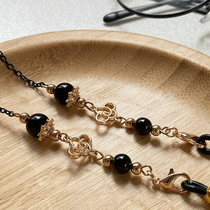 Filigree glasses chain holder with pearls and golden accents Kalsten