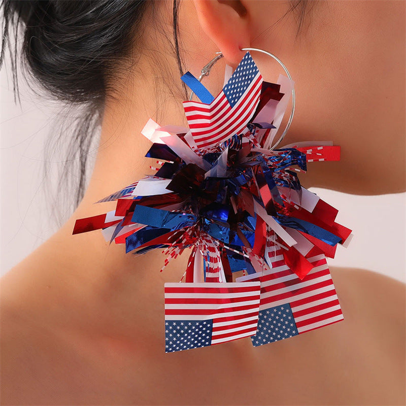 Women with eye-catching pompom hoops with lametta tassels and lightweight wire closure Kalsten