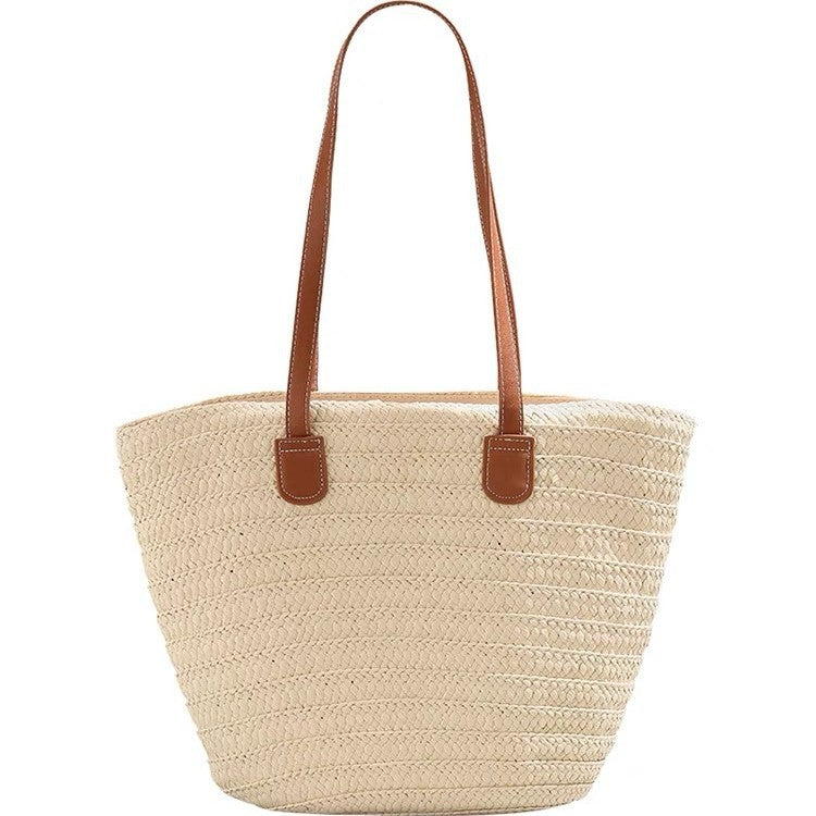 Stylish beach bag made of woven natural material with leather handles Kalsten
