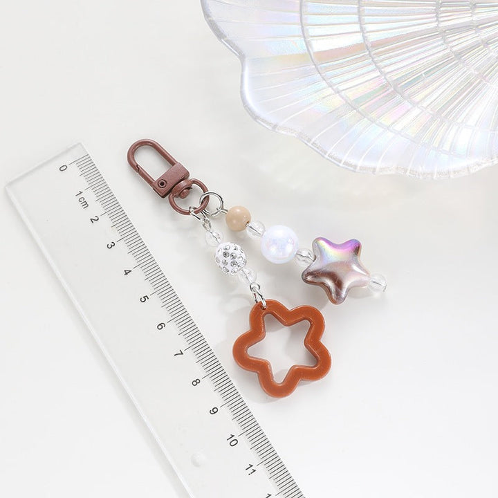 Playful keychain with floral and star motif Kalsten