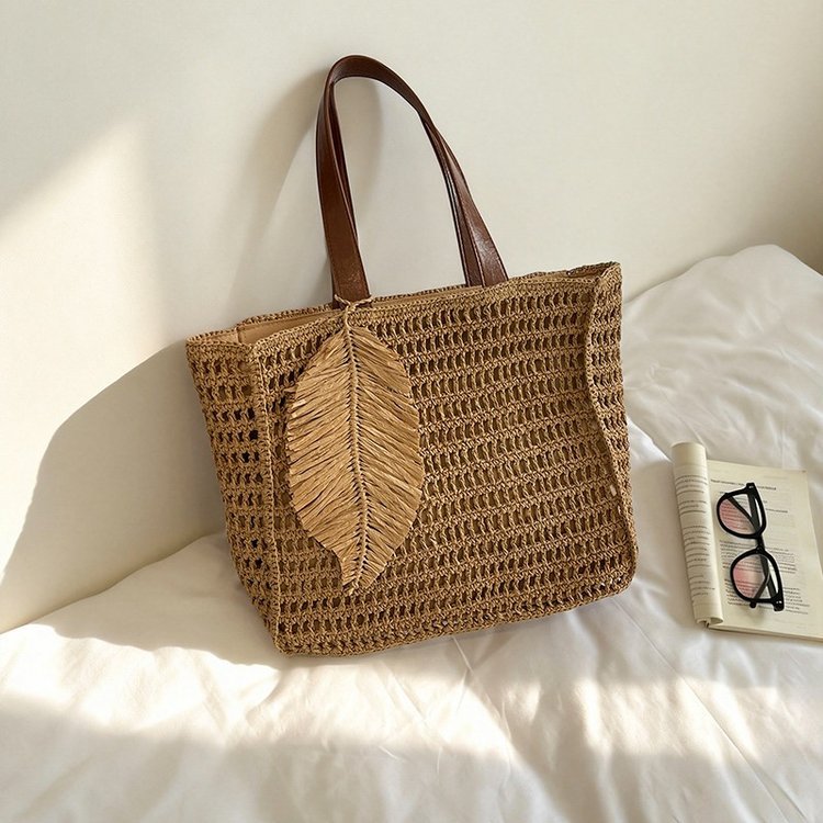 Handbag made of hand-woven natural material with decorative leaf shape design Kalsten