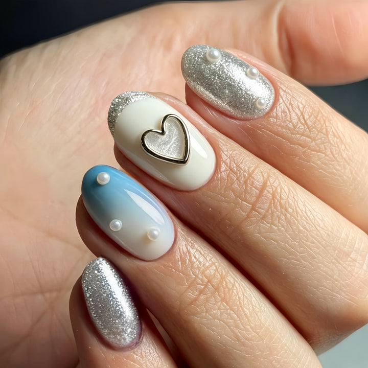 Glamorous artificial nails with heart design and pearl details Kalsten