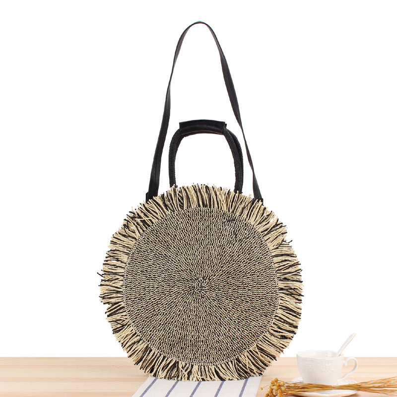 Round bag with fringe decoration Made of woven material Kalsten