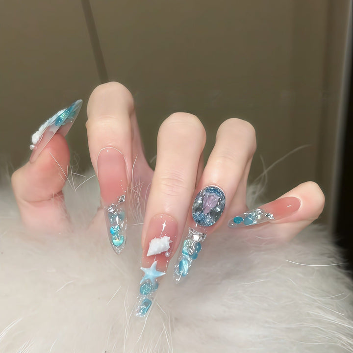 Creative artificial nails with maritime designs and sparkling accents Kalsten