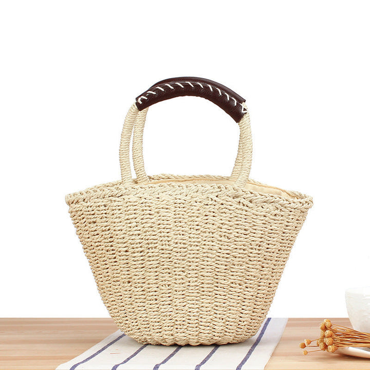 Basket bag made of woven natural material with leather handles Kalsten