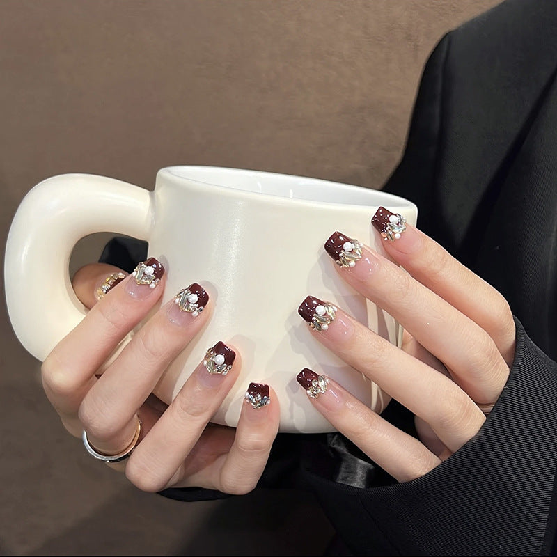 Glamorous artificial nails with decorative pearl and glitter embellishments Acalora