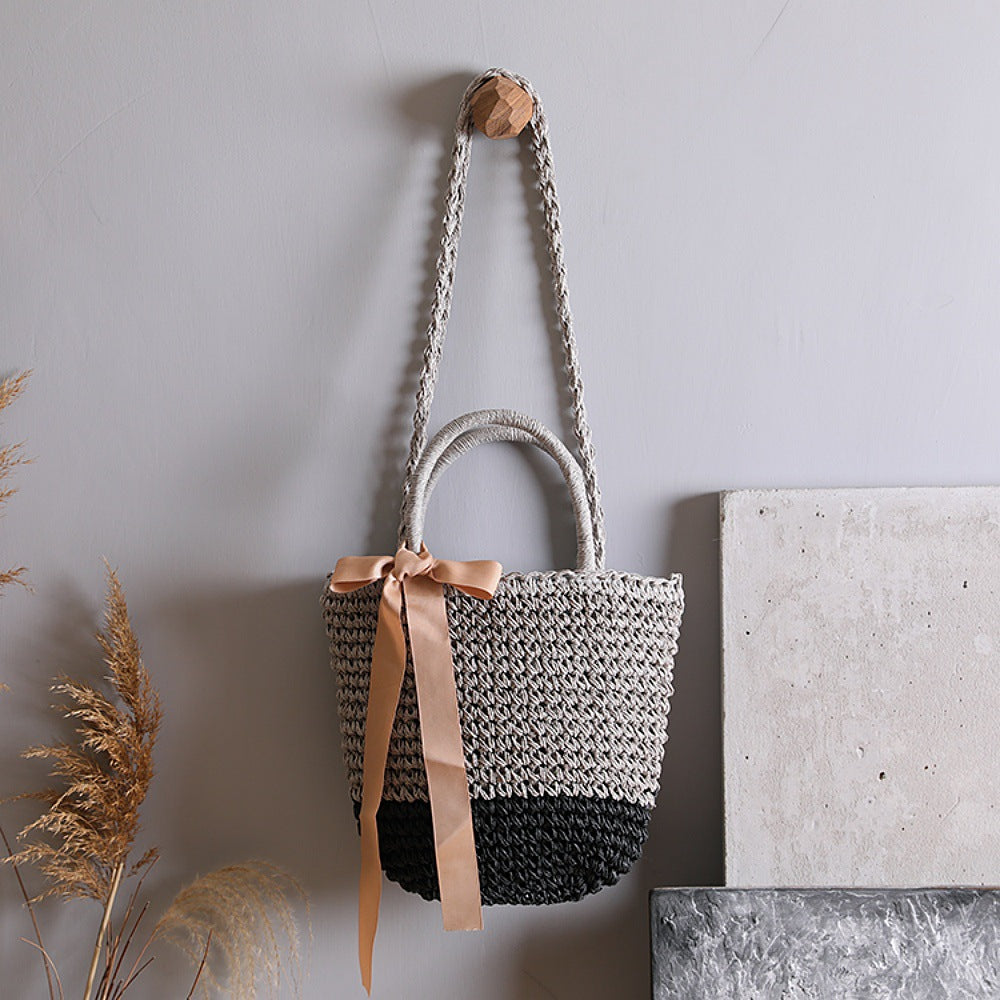 Basket bag with stylish carrying handles and decorative bow Kalsten