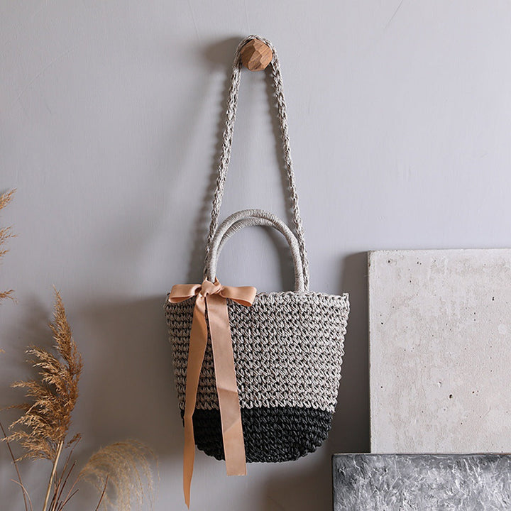Basket bag with stylish carrying handles and decorative bow Kalsten