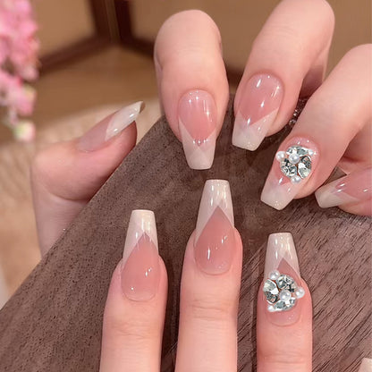 Artificial nail set with filigree tip designs and glamorous rhinestone accents Acalora