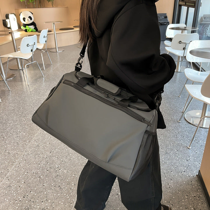 Sporty travel bag with reinforced carrying handles and multiple compartments Kalsten