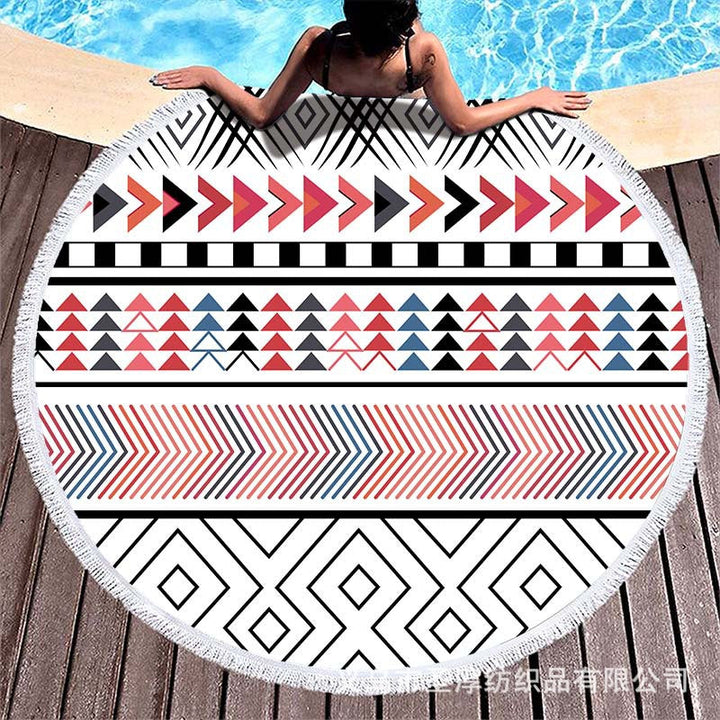 Round beach towel with colorful, tropical floral pattern and fringe decoration Kalsten