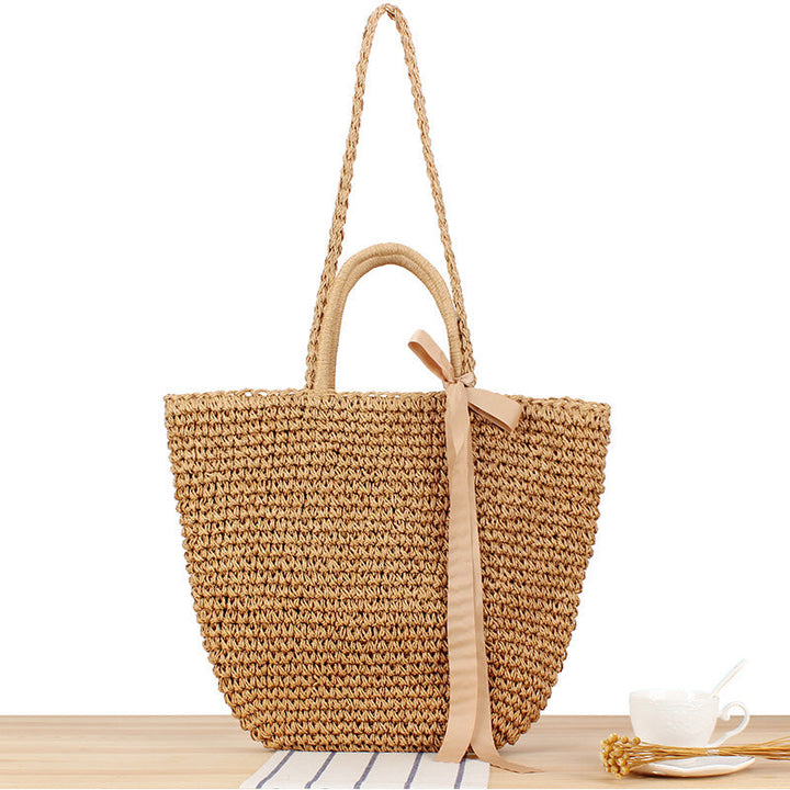 Beach bag made of natural raffia with playful design and elegant bow decoration Kalsten