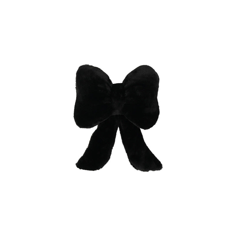 plush bow-shaped decorative throw cushion with long tails and faux-fur texture Kalsten