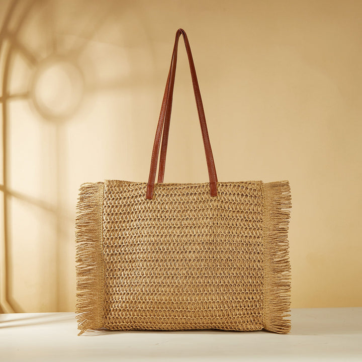 Beach bag made of raffia with fringed details Kalsten