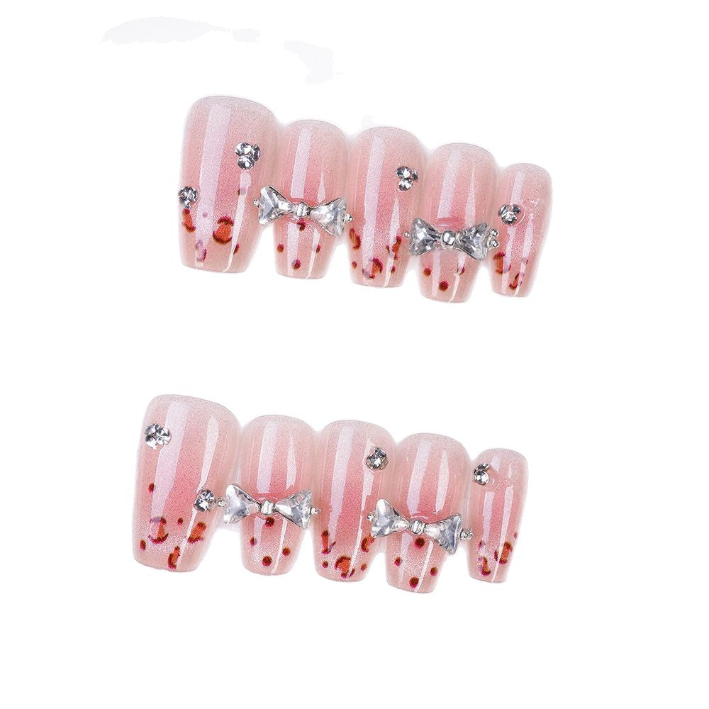 Art nails with delicate rhinestone and bow accents Kalsten