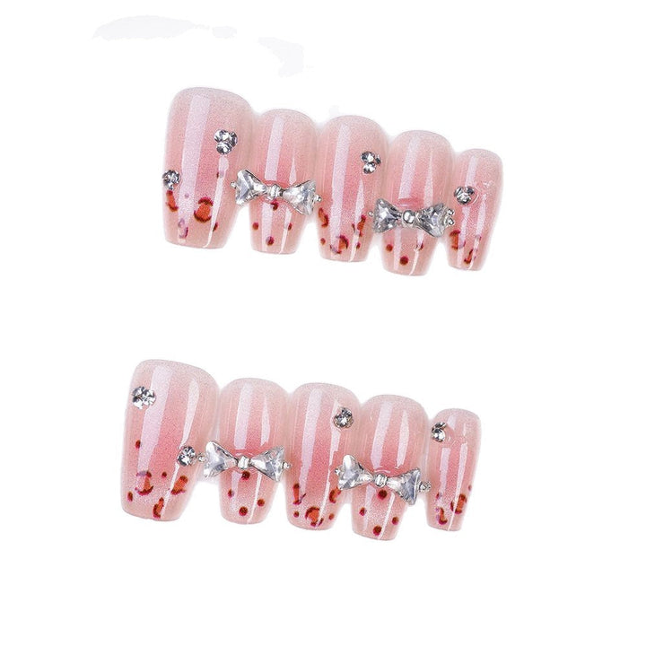 Art nails with delicate rhinestone and bow accents Kalsten