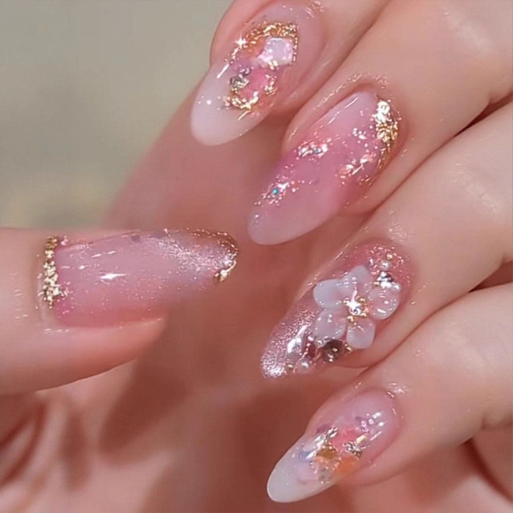 Art nail design with floral accents and glitter tips Acalora