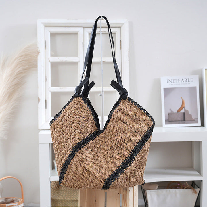 Handbag made of braided natural material with contrasting leather handles Kalsten