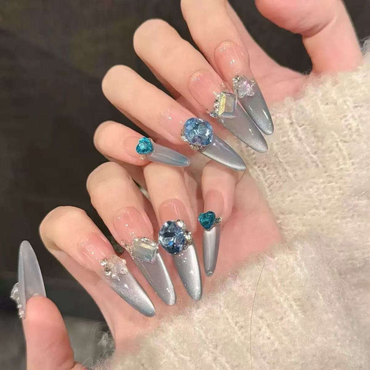 Acrylic nail set with elegant tips and glamorous rhinestone accents Acalora