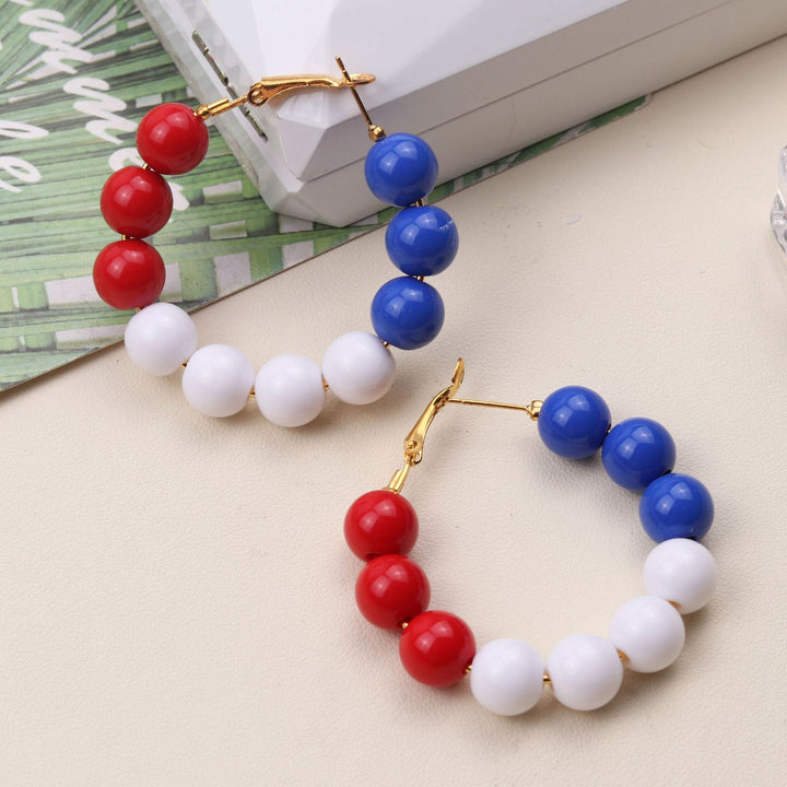 Women's pearl hoop earrings with large acrylic balls and secure clasp closure Kalsten