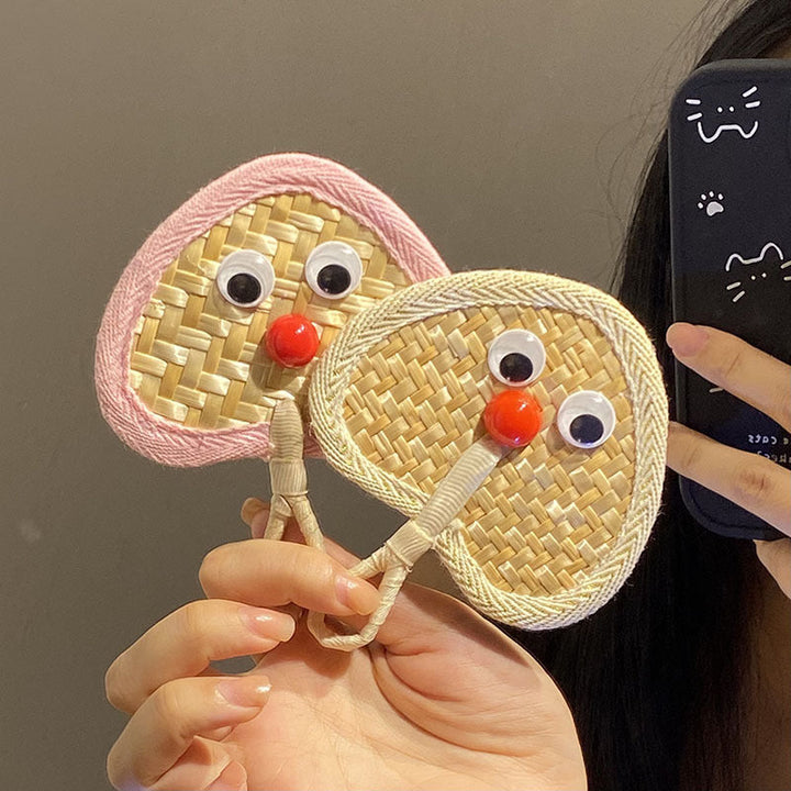 Handcrafted fan with playful face motif Kalsten