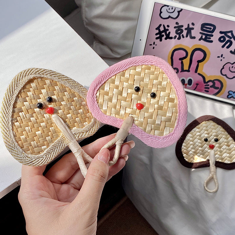 Handcrafted fan with playful face motif Kalsten