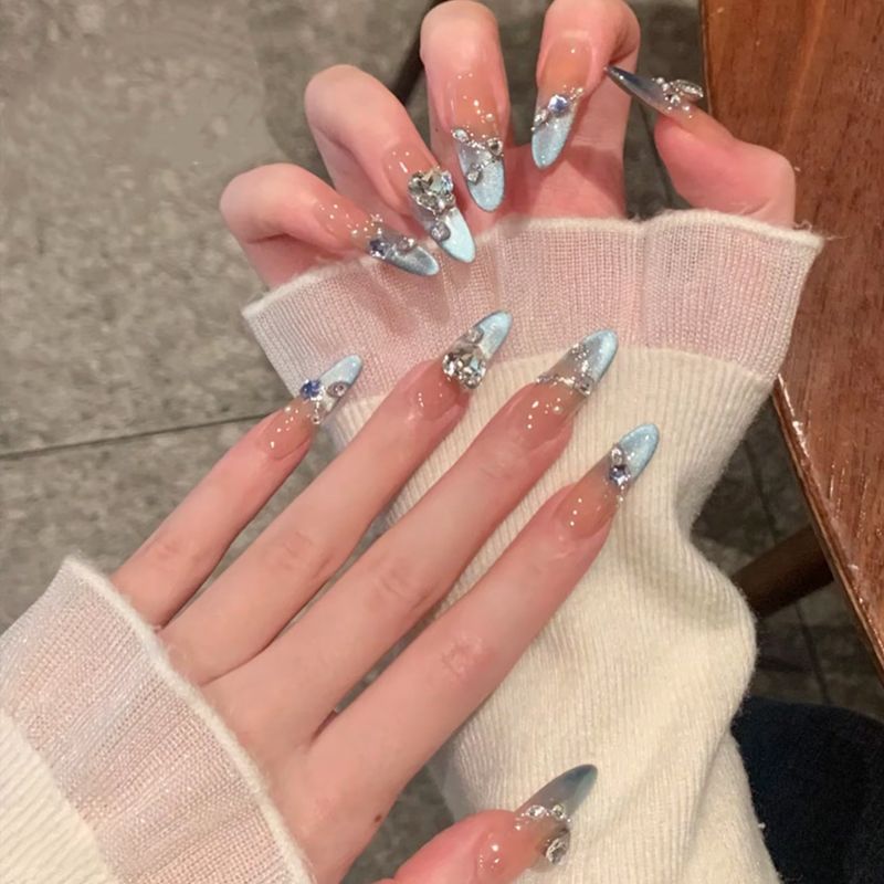 Acrylic nail set with elegant tips and glamorous rhinestone accents Acalora