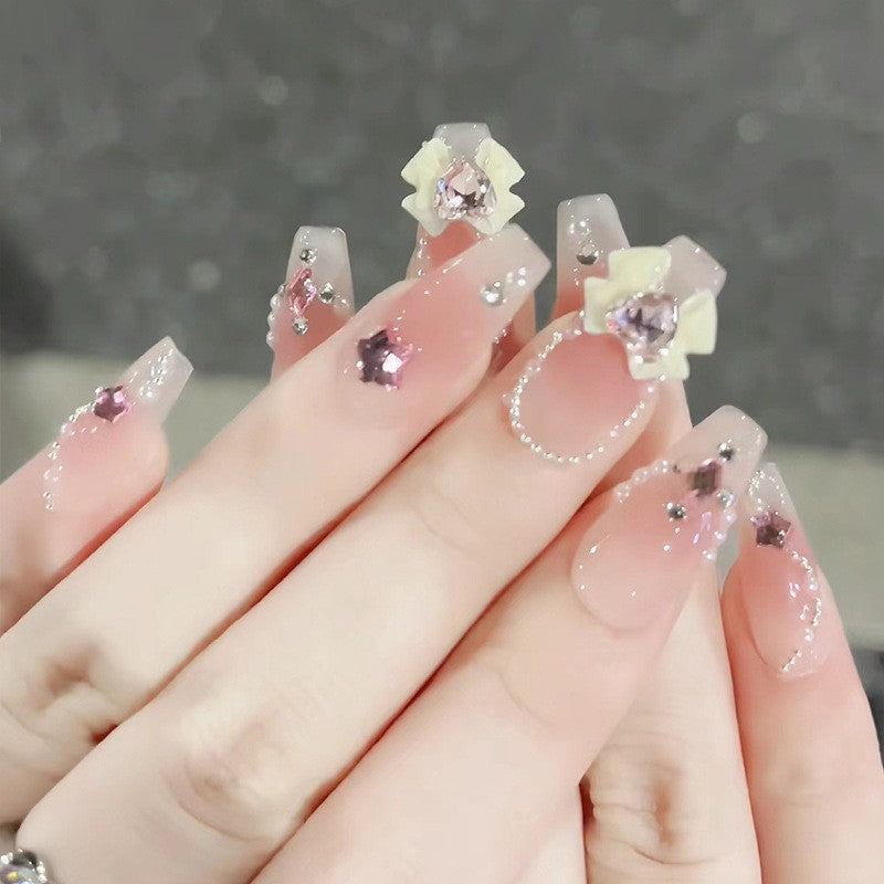 Artificial nails with glitter accents and playful motifs Kalsten