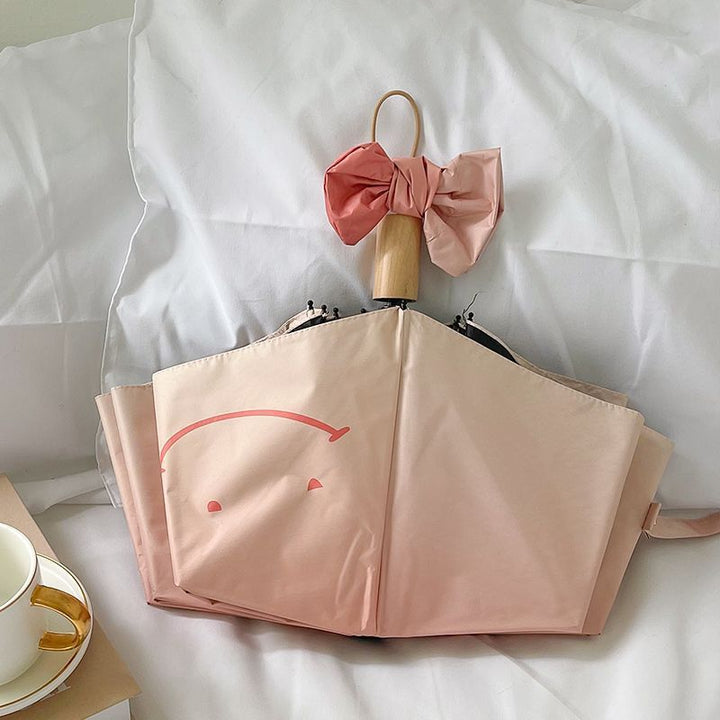 Women's foldable umbrella with playful design and handy wooden handle Kalsten