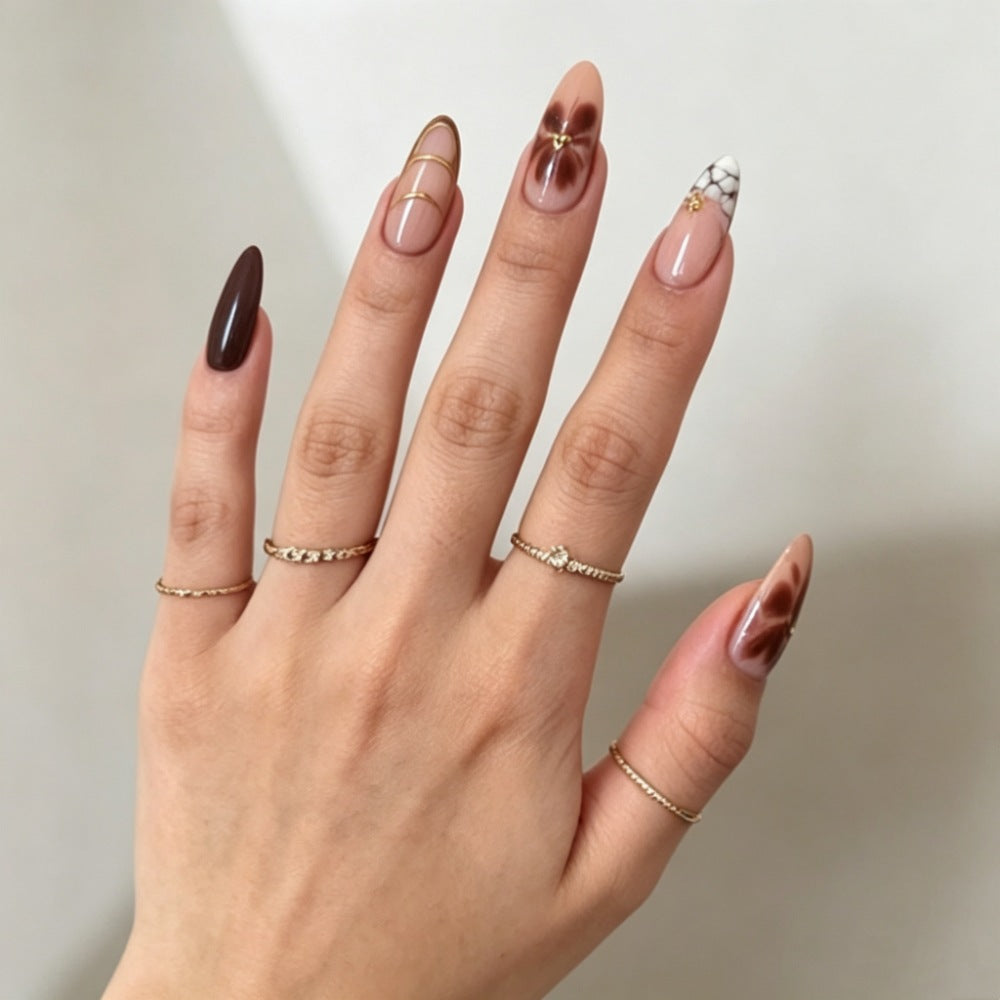 Artificial nails with elegant marble pattern and delicate accents Kalsten