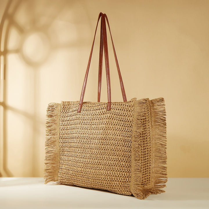 Beach bag made of raffia with fringed details Kalsten
