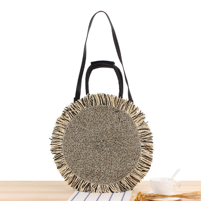 Round bag with fringe decoration Made of woven material Kalsten