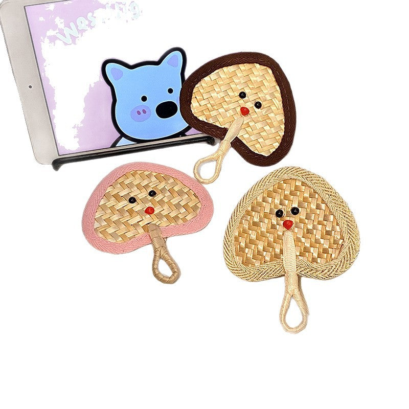 Handcrafted fan with playful face motif Kalsten