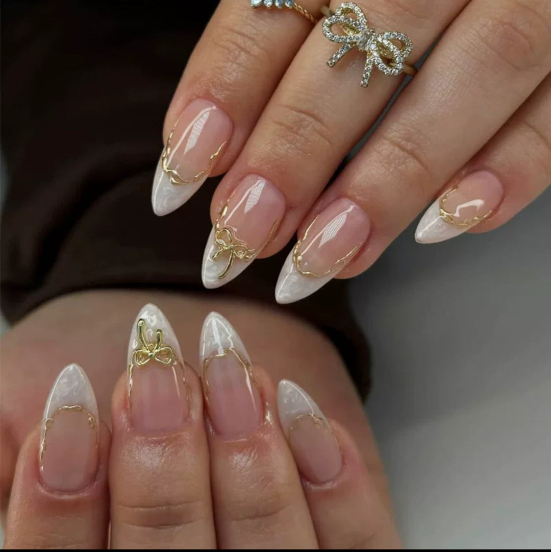 Artificial nails with elegant tip decorations and golden accents Kalsten