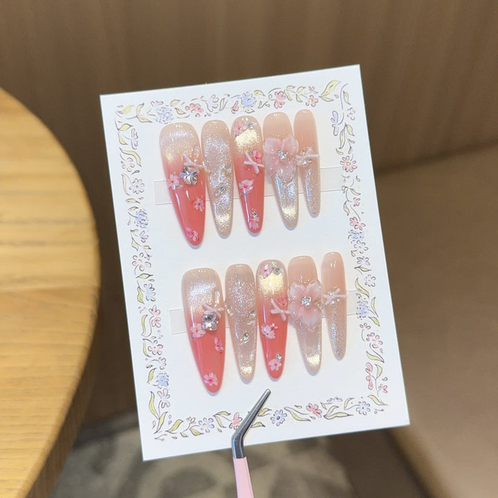 Artificial nails with floral embellishments and glitter effects Kalsten