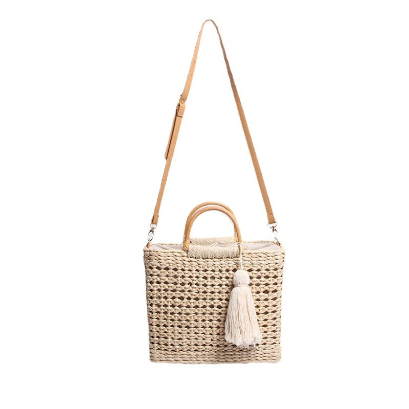 Handcrafted straw shoulder bag with decorative tassel pendant Kalsten