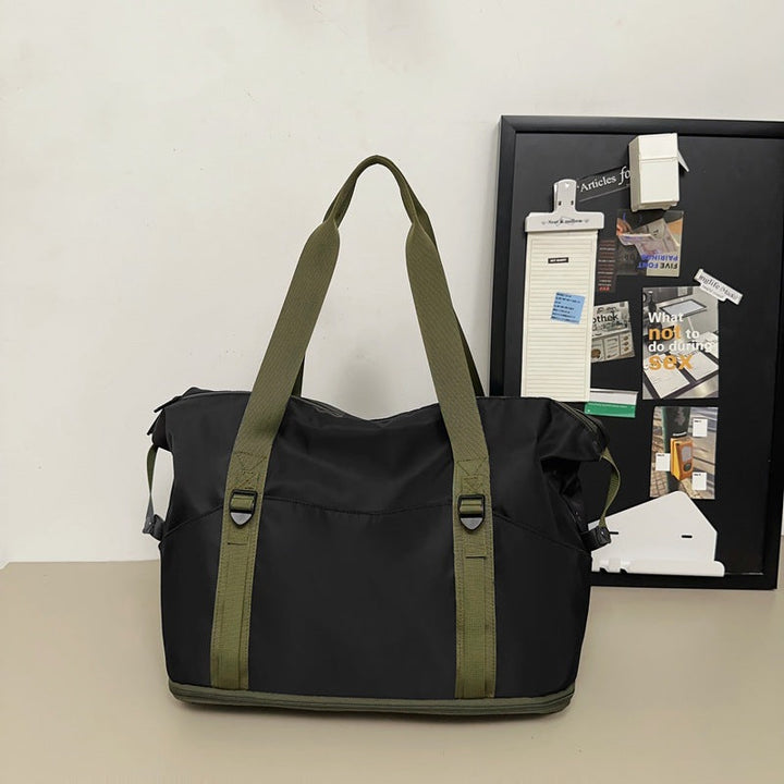 Sporty shoulder bag with water-repellent material and sturdy carrying handles Kalsten
