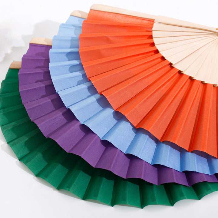 Ladies folding hand fan made of airy material with intricate folds Kalsten