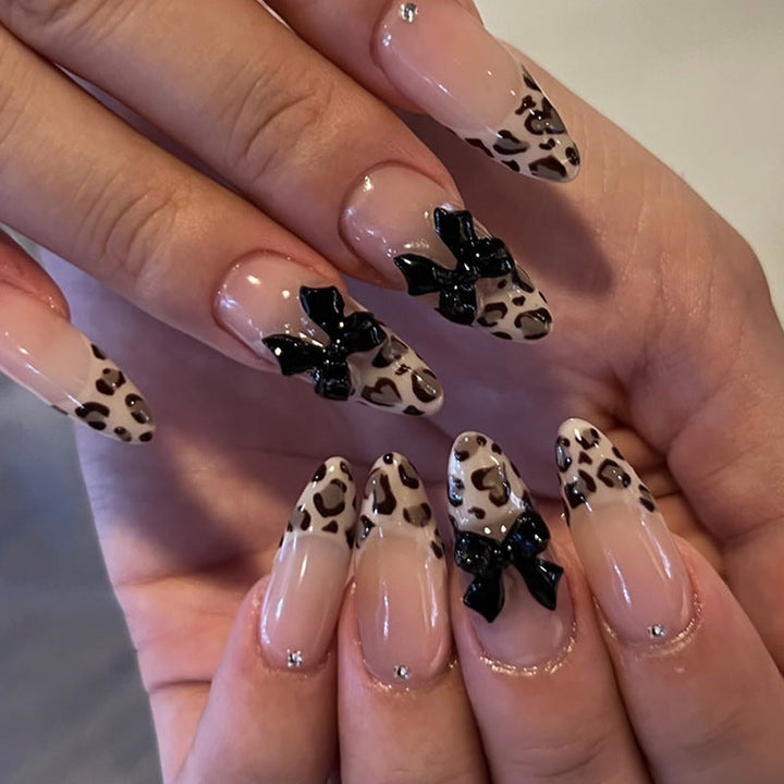 Creative artificial nails with stylish leopard pattern and bow accents Kalsten