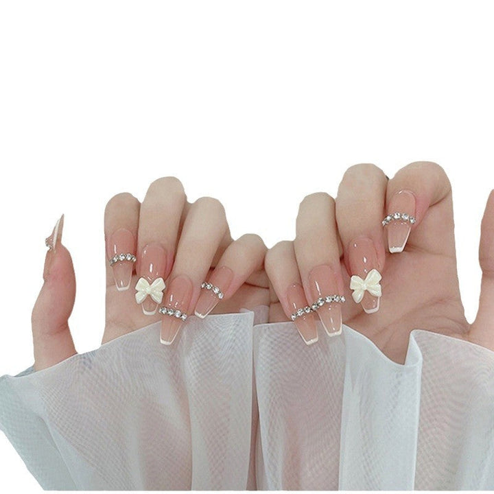 Artificial nails with elegant bow accents and pearl decorations Kalsten