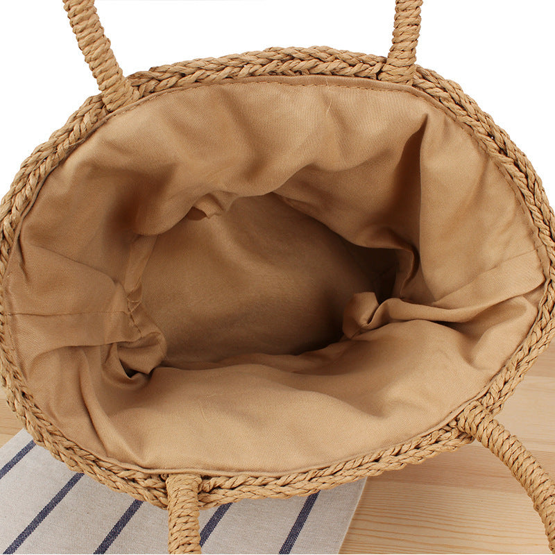Basket bag made of woven natural material with leather handles Kalsten