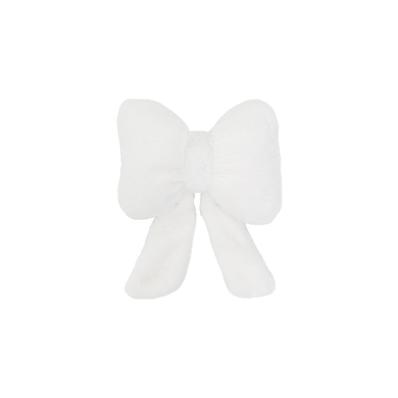 plush bow-shaped decorative throw cushion with long tails and faux-fur texture Kalsten