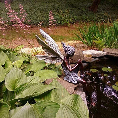Statue of a sitting fairy in the garden