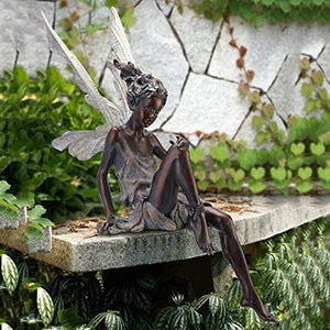Statue of a sitting fairy in the garden